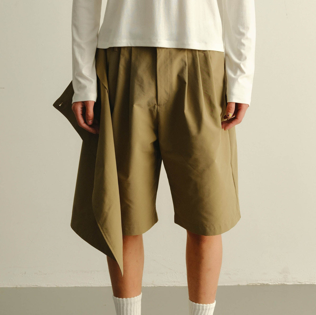 KADAKADA Asymmetrical Overlay Pleated Shorts
