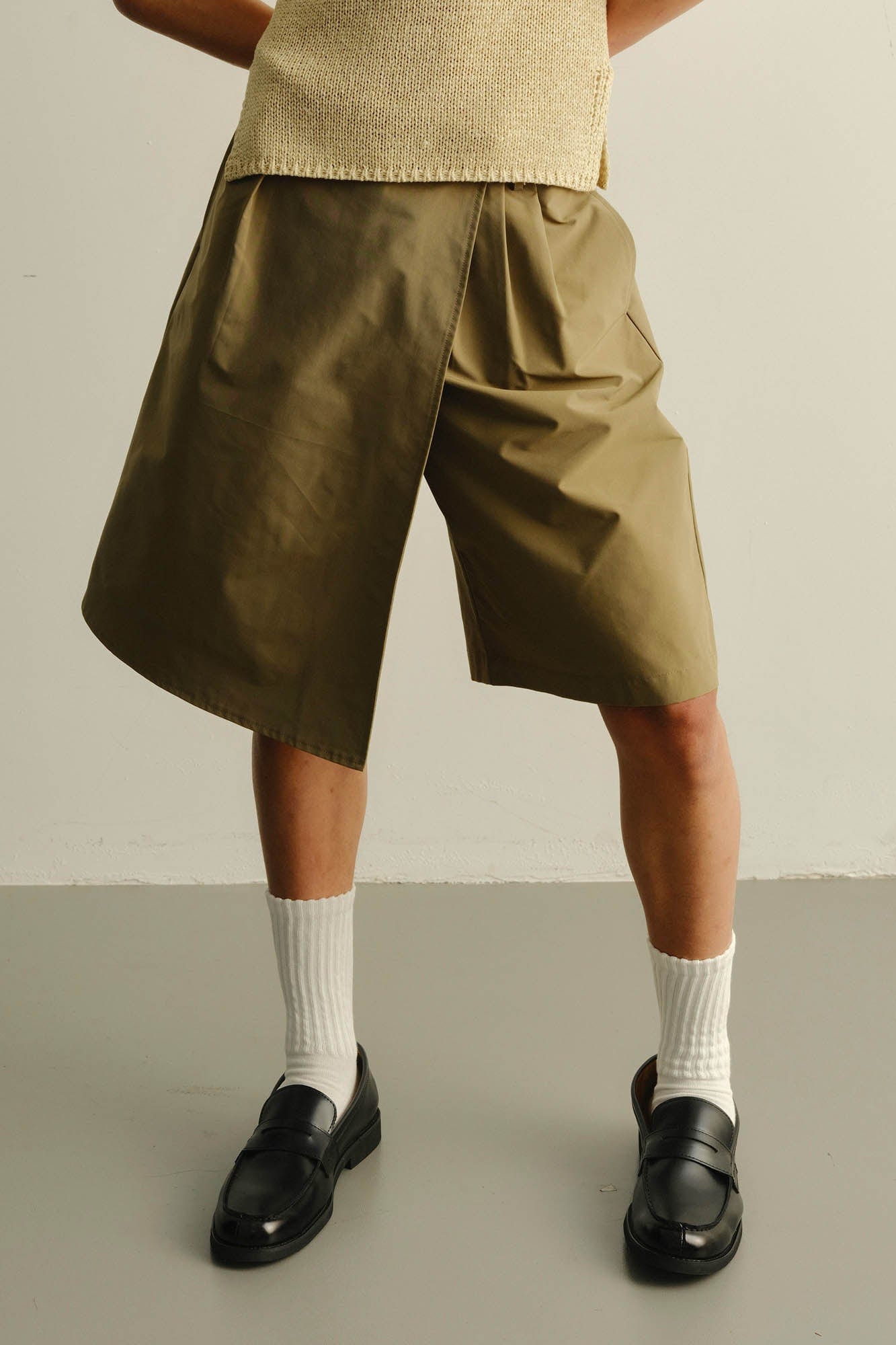KADAKADA Asymmetrical Overlay Pleated Shorts