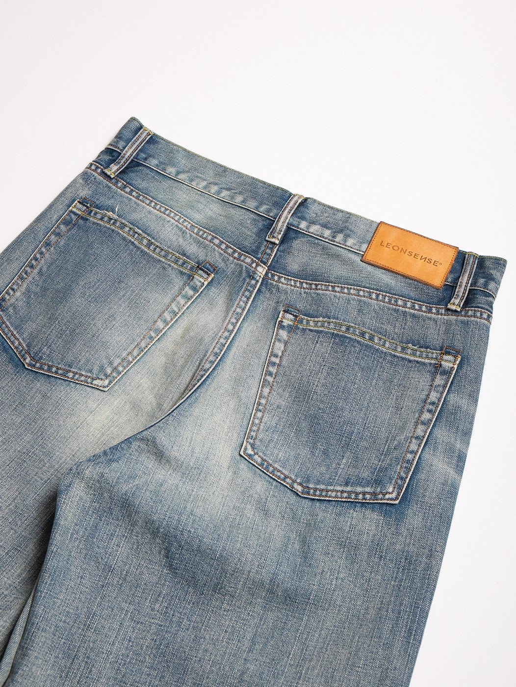 LEONSENSE Raw Edge Washed Flared Jeans